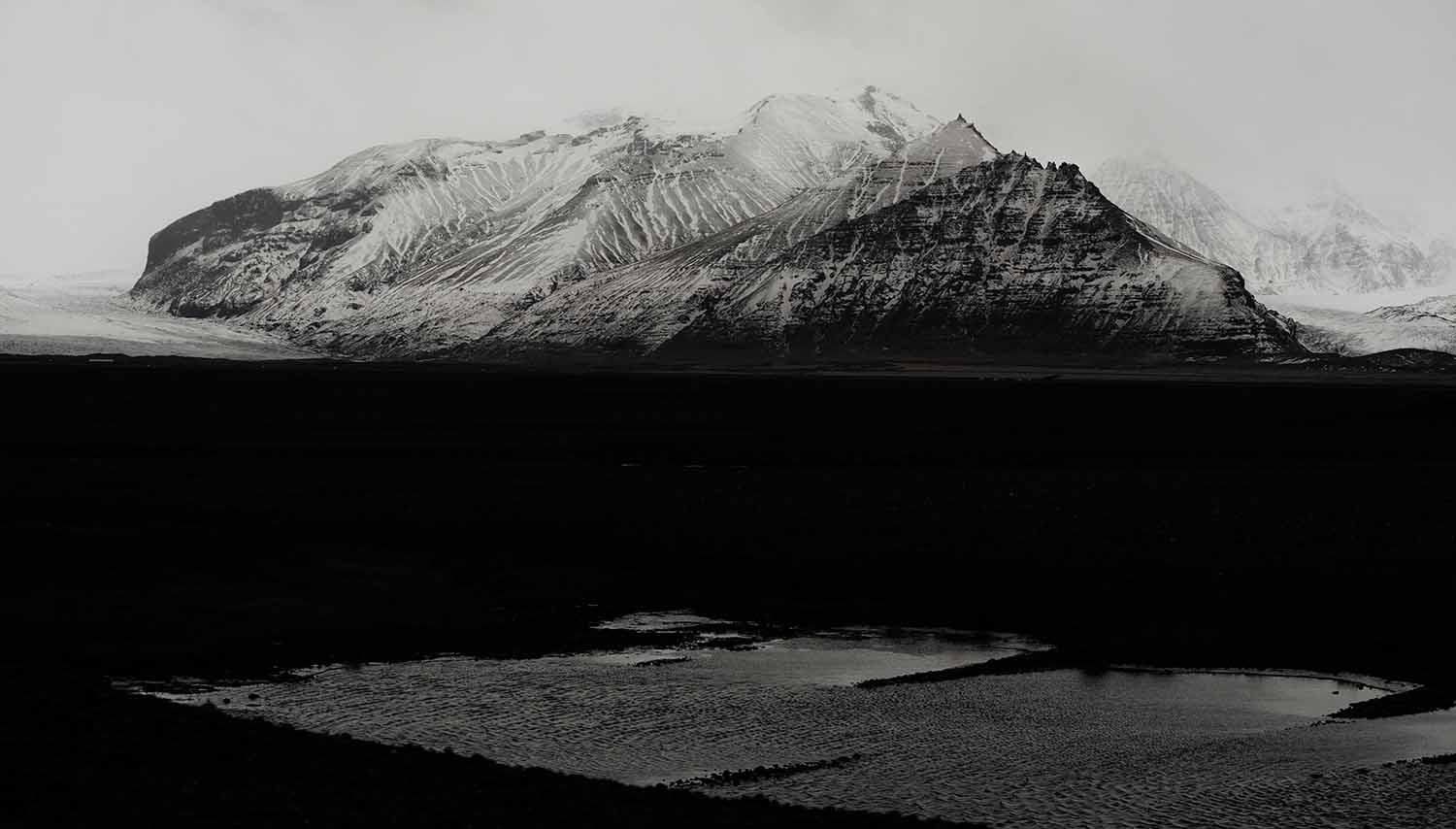 a snowy mountain range in the distance